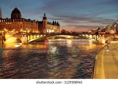 Paris, France, 75009, 01/07/2018, Sunset View Of The Bridge Pont Au Change And The Conciergerie From The Notre Dame Bridge. Bycicle Riding On The Dock Free Of Cars.