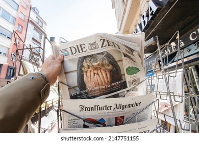 Paris, France - Apr 11, 2022: POV Male Hand Taking From Stand Die Zeit German Newspaper With Headline Breaking News Feature With Ukraine Woman Crying During The War In Ukraine