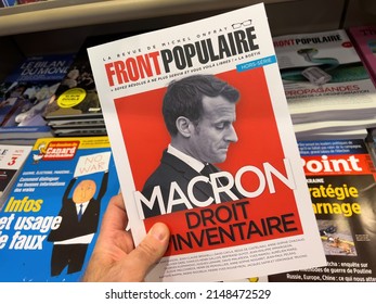 Paris, France - Apr 11, 2022: POV Male Hand Buy Front Populaire Magazine Newspaper Press Headlines With French President Emmanuel Macron - Presidential Election Of 2022