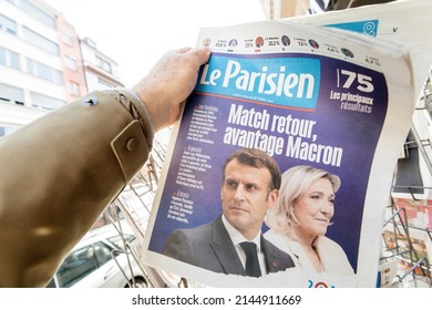 Paris, France - Apr 11: Man buy looks at press kiosk Le Parisien French newspaper Emmanuel Macron, Marine Le Pen a day after first round of French Presidential election on April 10 2022