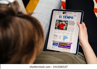Paris, France - Apr 15, 2019: Woman reading El Tiemo on iPad Pro Apple News Plus digital newspaper featuring breaking news on cover about Golf player Tiger Woods