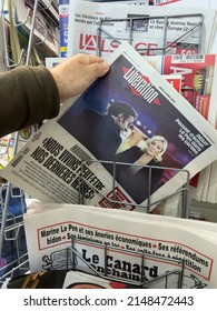 Paris, France - Apr 21, 2022: POV Male Hand Buy Liberation Newspaper Press Headlines After Debate Between Marine Le Pen And French President Emmanuel Macron - Presidential Election Of 2022