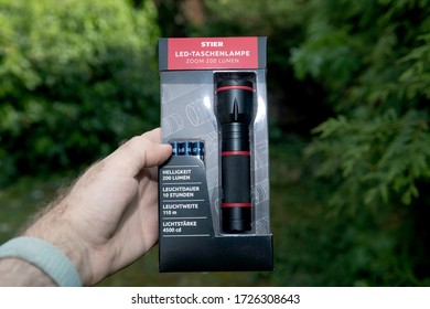 Paris, France - Apr 24, 2020: Man Hand POV Personal Perspective At New Packaging With Stier German Flashlight With LED Light