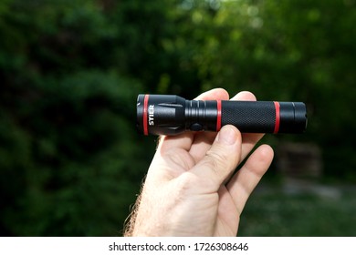 Paris, France - Apr 24, 2020: Man Hand POV Personal Perspective At New Stier German Flashlight With LED Light