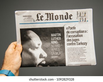 PARIS, FRANCE - APR 3, 2018: Man Reading Pov Le Monde Newspaper Front Page Against White Background With The Picture Of The Martin Luther King Death 50th Anniversary