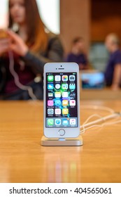 PARIS, FRANCE - APR 4, 2016: People Testing New IPhone With The Apple IPhone SE In Docking Station During The Sales Launch Of The Latest Apple Inc. Smartphone And IPad Pro At The Apple Store In Paris