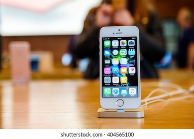 PARIS, FRANCE - APR 4, 2016: People Testing New IPhone With The Apple IPhone SE In Docking Station During The Sales Launch Of The Latest Apple Inc. Smartphone And IPad Pro At The Apple Store In Paris