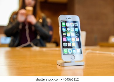 PARIS, FRANCE - APR 4, 2016: People Testing New IPhone With The Apple IPhone SE In Docking Station During The Sales Launch Of The Latest Apple Inc. Smartphone And IPad Pro At The Apple Store In Paris