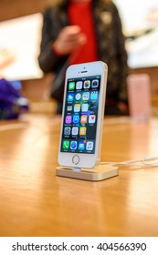 PARIS, FRANCE - APR 4, 2016: People Testing New IPhone With The Apple IPhone SE In Docking Station During The Sales Launch Of The Latest Apple Inc. Smartphone And IPad Pro At The Apple Store In Paris