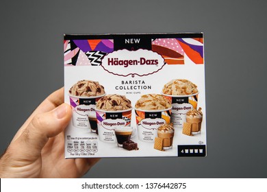 Paris, France - Apr 6, 2019: Man Hand Holding Against Gray Background Package Of Haagen-Dazs Barista Collection Ice Cream With Diffrent Tastes And New Collection