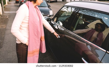 PARIS, FRANCE - APR 8, 2018: Woman Open The Door Of Mini Cooper Car Parked On A French Street