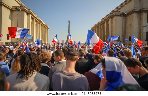 paris, france- april 12 2022 : crowd waving
french flags on Trocadero Square in front of the Eiffel tower,
french politic and
patriotism