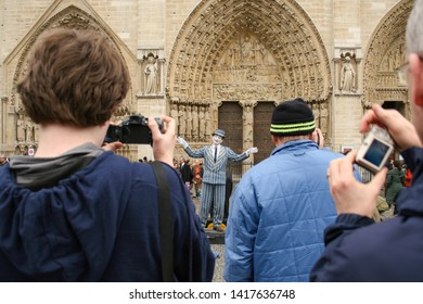 Paris, France - April 13 2008 - A Crowd Photographs A Busker Dressed As A Mime Performing In Front Of Notre Dame Cathedral.  