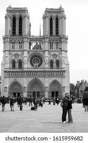 Paris, France - April 13 2008 - A Black And White Image Of A Couple Taking A Selfie Outside Of Notre Dame Cathedral On Île De La Cité In The 4th Arrondissement Of Paris, France.  Image Has Copy Space.