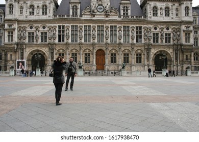 Paris, France - April 13 2008 - A Woman Takes A Picture Of A Man Outside Of Hotel De Ville, Which Means City Hall, In The 4th Arrondissement Of Paris, France.  Image Has Copy Space.