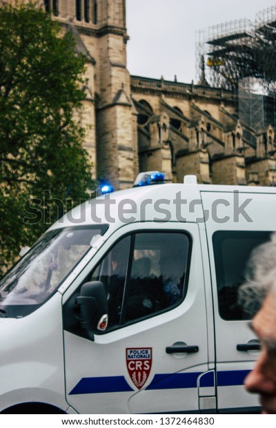Paris France April 16, 2019 View of a French\
police car parked near the Notre Dame cathedral in Paris the day\
after the big fire in the\
afternoon