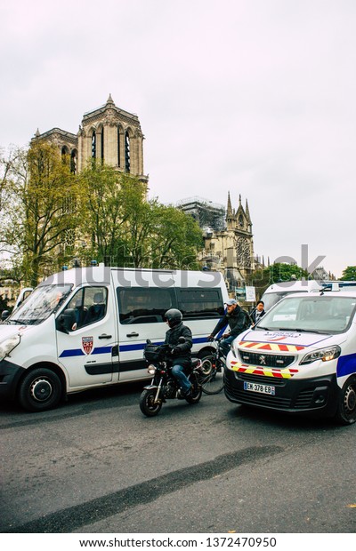 Paris France April 16, 2019 View of a French\
police car near the Notre Dame cathedral in Paris the day after the\
big fire in the afternoon