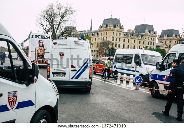 Paris France April 16, 2019 View of a French\
police car near the Notre Dame cathedral in Paris the day after the\
big fire in the afternoon