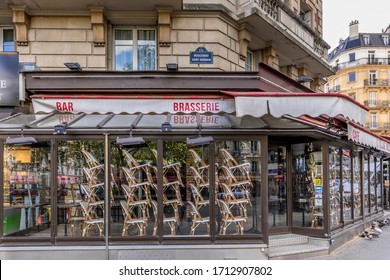 Paris, France - April 17, 2020: Restaurant Brasserie On Boulevard Saint Germain Is Closed Due To Epidemic Of Coronavirus COVID19 In Paris. Empty Bar, Chairs Raised, No Guests. Sunny Spring Evening