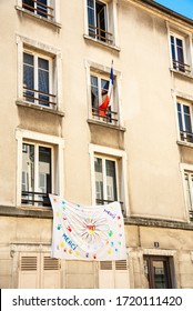 Paris, France - April 23, 2020: Thank You Banner And French Flag Hanging On House In Parisian Suburb To Express Gratitude And To Support Front Line Workers During Coronavirus Covid-19 Outbreak.