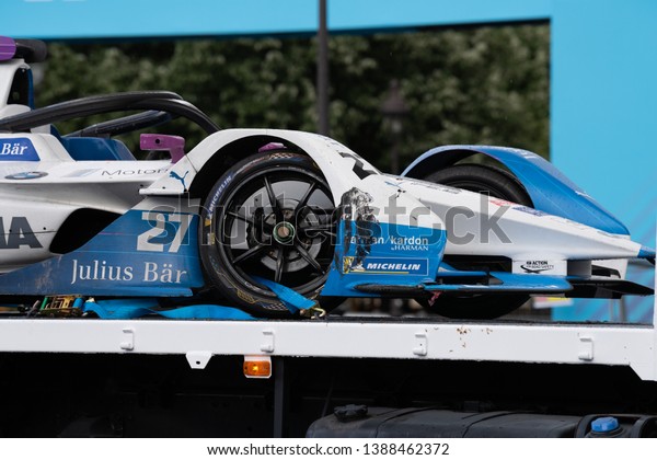 PARIS, FRANCE - April 27th, 2019 : The car of\
Alexander Sims from BMW I Andretti Motorsport team on a tow truck\
after the ePrix ABB FIA Formula-E, the class of motorsport 100%\
electric-powered cars.