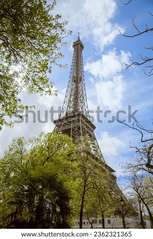 Similar – Eiffel Tower in green trees on blue sky