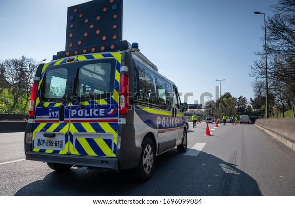PARIS, FRANCE - April 5 2020 : \
French police\
checkpoint on the Paris ring road to check whether drivers and\
passengers are in order to move around during the containment\
measures due to\
Covid-19.