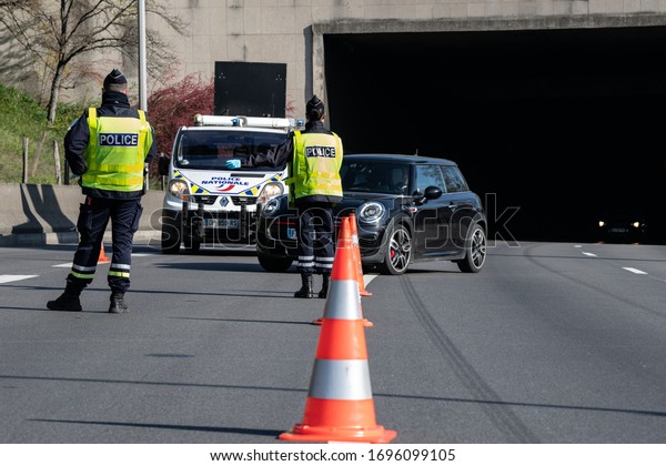 PARIS, FRANCE - April 5 2020 : \
French police\
checkpoint on the Paris ring road to check whether drivers and\
passengers are in order to move around during the containment\
measures due to\
Covid-19.