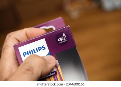 Paris, France - Aug 2, 2021: Pov Personal Perspective At Male Hand Holding New Package Of Philips Led Eye Comfort Light Bulb