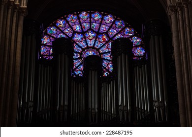 Paris, France - August 11, 2014: Round Medieval Stained Glass Window And Organ In Dark Interior Of  Notre Dame De Paris Cathedral, France