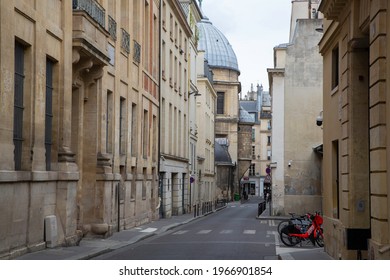 Paris, France. August, 2019. Empty street at the parisian district of Saint Germain des Prés and the backside of the historic Church of Saint Sulpice with aged domes in the background