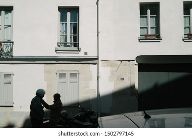 Paris, France – August 2019: Gay Couple Parking Scooters On A Daylight Sun.