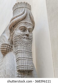 PARIS, FRANCE - AUGUST 28 2013: - Closeup Of Winged Assyrian Bull Head, Khorsabad, Representing Benevolent Spiritual Guardians Part Of Ancient Mesopotamian History Exhibited In Louvre Museum