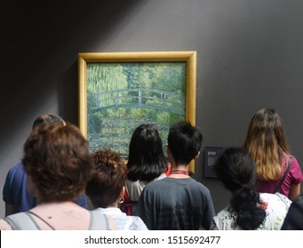 Paris, France - August 29, 2019: Crowd Of Visitors Near The Water-Lily Pond, Symphony In Green 1899 By Claude Monet Painting In Museum D'Orsay In Paris, France.