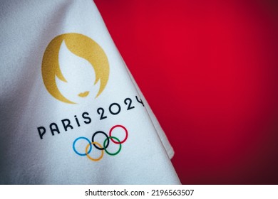 PARIS, FRANCE, AUGUST 8. 2022: Summer Olympic Games Paris 2024. Official Logo On White Blanket With Red Background. Sport Photo, Red Edit Space For Your Text Or Montage