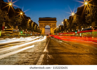 PARIS, FRANCE - CIRCA JULY 2015: Evening View Down The Champs-Élysées Avenue With The Arc De Triomphe In The Back. 