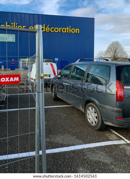 Paris, France - Dec 1, 2018: Fence near parking of\
large IKEA furniture\
store