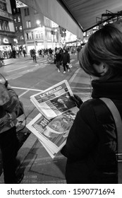 Paris, France - Dec 14, 2019: Woman Holding Near Press Kiosk French Le Figaro Newspaper After UK Prime Minister Boris Johnson's Won A Landslide Early General Parliamentary Victory Black And White