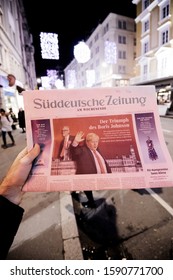 Paris, France - Dec 14, 2019: Man Reading In The City Suddeutsche Zeitung The Day After UK Prime Minister Boris Johnson's Conservative Party Won A Landslide Early General Parliamentary Victory