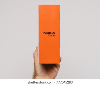 PARIS, FRANCE - DEC 18, 2017: Man holding against white background vintage and luxury NOKIA box of a E71 eseries business smartphone - orange side 