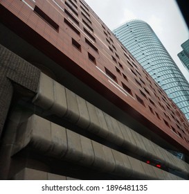 Paris, France - Dec. 2020 - Low Angle View On Ancre Residence Apartment Building, Which Is Constructed On Its Above-ground Car Park And Is Dominated By The Newly-built Glass Skyscraper Tour Alto