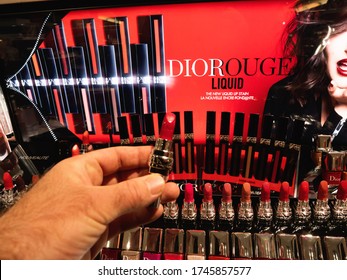 Paris, France - Dec 9, 2017: POV Male Hand Personal Perspective Holding Buying Red Lipstick Manufactured By Christian Dior In Sephora Store Travesty Experience