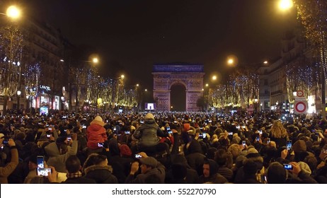 PARIS, FRANCE - DECEMBER, 31, 2016. Overhead Shot Of Crowded Champs-Elysees Street And Light Show On Famous Triumphal Arch, Arc De Triomphe. New Year's Eve