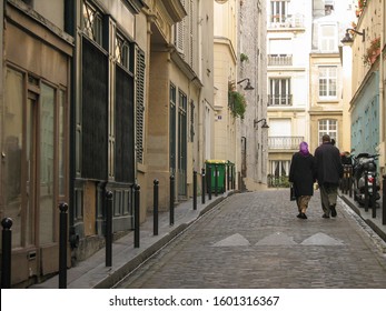 Paris, France - December 5 2007 - An Unidentified Middle Aged Couple Walking Down The Street Holding Hands Through The Streets Of Paris, France.  Image Has Concept Of Romance And Has Copy Space.