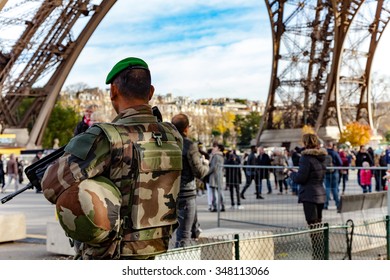 Paris, France - December 5, 2015: French Soldier Guarding The Eiffel Tower To Prevent Terrorism.