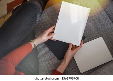 Paris, France - Feb 12, 2019: Overhead View Of Elegant Woman Holding Package Of New Folio Pad Cover For New Ipad Pro Tablet By Apple Computers On The Couch In Living Room