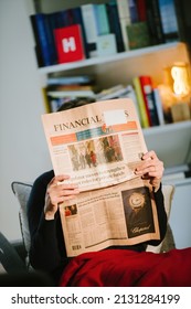 Paris, France - Feb 23, 2022: Woman Reading Financial Times Newspaper With The Cover Headline After Covid 19, England To End Isolation Rules