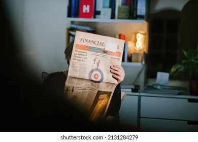 Paris, France - Feb 23, 2022: Woman reading British Financial Times newspaper with the cover headline EU prepares gas options if Ukraine crisis hits supplies