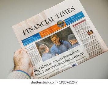 Paris, France - Feb 4, 2021: POV Male Hand Holding Lates Financial Times Newspaper Reading About Navalny Given 3 And A Half Years In Jail