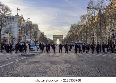 Paris, France - February 12 2022 : Line Of Anti Riot Police Squad Deployed On Champs Elysées Avenue During Freedom Convoy Protest